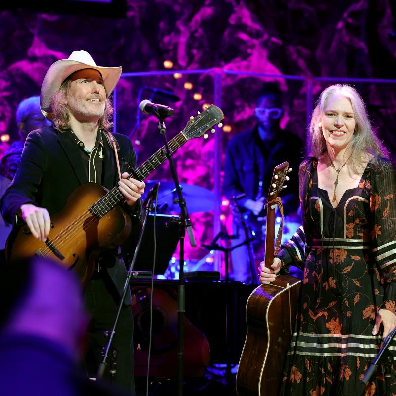 Gillian Welch and David Rawlings on stage looking out at the crowd